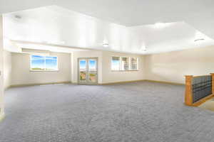 Carpeted empty room with baseboards and a smoke detector