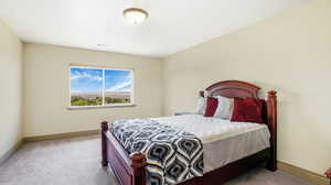 Bedroom featuring carpet and baseboards
