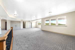 Empty room with carpet flooring and baseboards