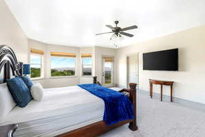 Carpeted bedroom featuring baseboards and ceiling fan