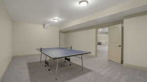 Game room featuring light carpet and baseboards