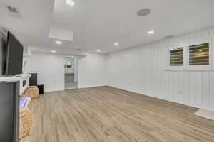 Unfurnished living room featuring light wood finished floors, baseboards, and recessed lighting