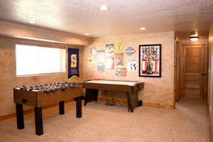 Rec room with carpet floors, a textured ceiling, recessed lighting, and baseboards