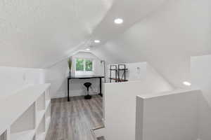 Attic loft room featuring an mini split and built in storage