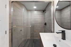 Full bathroom featuring a stall shower and vanity