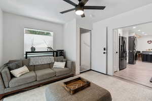 Living room with ceiling fan, recessed lighting, and gray laminate flooring
