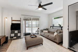 Living room with a sliding glass door leading into a sun room