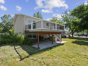 Back of property with a patio, stairway, and a deck