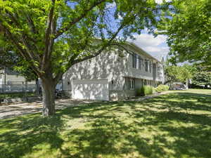 View of home's exterior with a garage and driveway