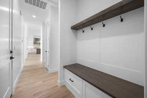 Mudroom featuring baseboards, light wood-type flooring, and recessed lighting