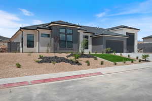 Prairie-style house with a garage, a tile roof, concrete driveway, and stucco siding