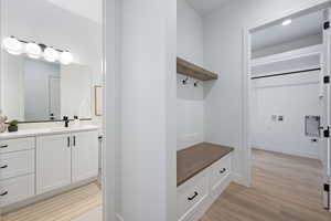 Mudroom featuring a sink and light wood-style flooring