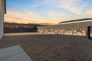 Yard at dusk with a fenced backyard