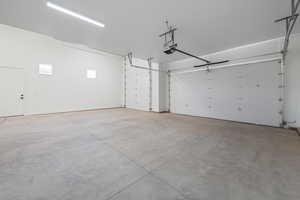 Garage featuring a garage door opener