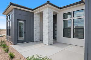 Property entrance with a patio area and brick siding
