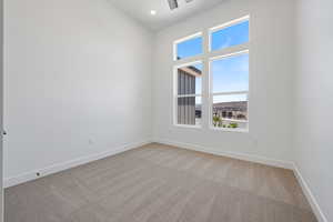 Empty room with light colored carpet, baseboards, ceiling fan, and recessed lighting