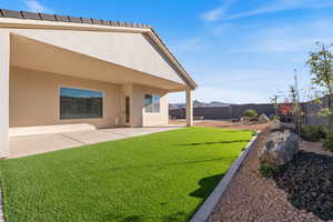 Fenced backyard featuring a patio and a mountain view