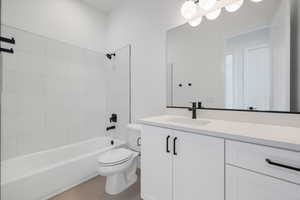 Bathroom featuring vanity, toilet, shower / bathtub combination, and tile patterned flooring