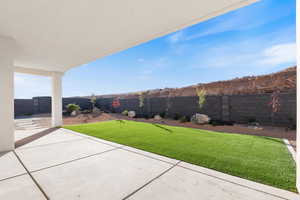 Fenced backyard with a patio