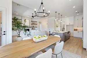 Dining space featuring a chandelier, light wood-style floors, and recessed lighting