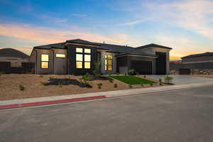View of front of house featuring an attached garage and concrete driveway