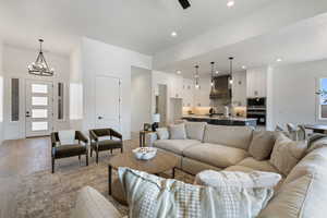 Living room featuring a chandelier, light wood finished floors, and recessed lighting