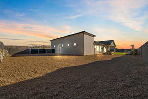 Rear view of house featuring a fenced backyard