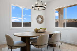 Dining space featuring a chandelier and light wood-type flooring