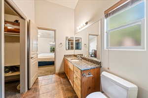 Bathroom with ensuite bathroom, vanity, and toilet