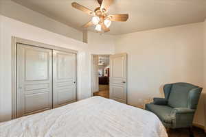 Bedroom featuring carpet, a ceiling fan, and a closet