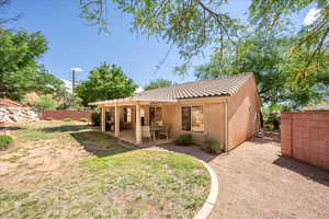 Back of property with a patio area, stucco siding, and a tile roof