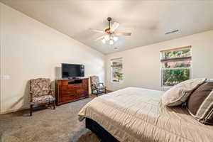 Bedroom with carpet floors, lofted ceiling, a ceiling fan, and baseboards