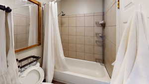 Full bath with shower / bath combo and toilet
