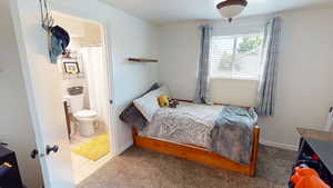 Bedroom featuring ensuite bathroom and tile patterned flooring