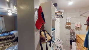 Spacious closet featuring a ceiling fan