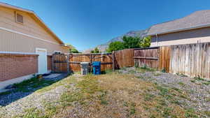 Fenced backyard featuring a mountain view