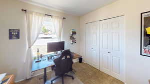 Carpeted office space with baseboards