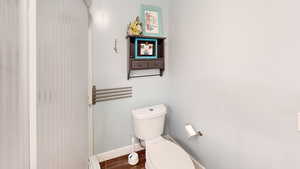 Bathroom featuring toilet and baseboards