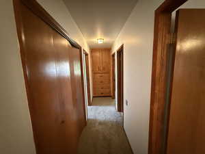 Corridor featuring carpet floors
