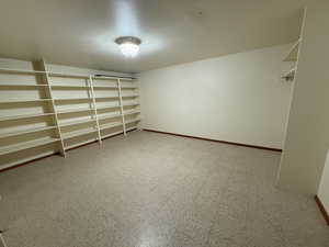 Walk in closet with tile patterned floors
