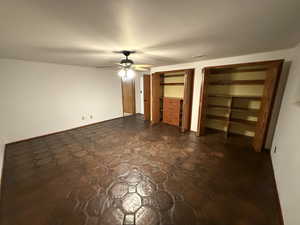 Unfurnished bedroom with two closets and ceiling fan