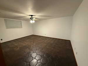 Spare room featuring ceiling fan and baseboards