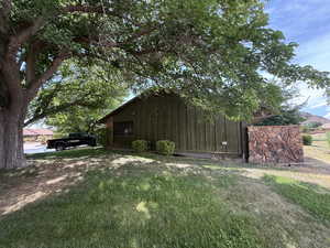 View of side of home featuring a yard