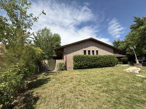 View of home's exterior with a yard