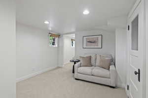 Sitting room featuring carpet floors, baseboards, and recessed lighting