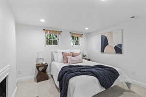 Bedroom with carpet, baseboards, and recessed lighting