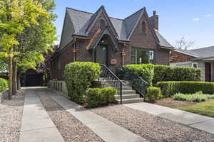 Tudor-style house featuring brick siding and a chimney