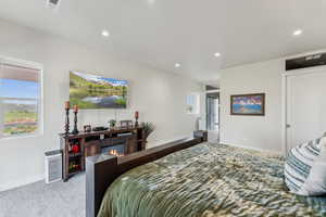 Carpeted bedroom with recessed lighting and baseboards