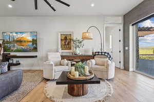 Living area with light wood-style floors, ceiling fan, baseboards, and recessed lighting