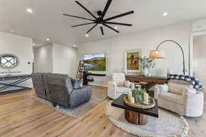Living room with a ceiling fan, recessed lighting, and wood finished floors